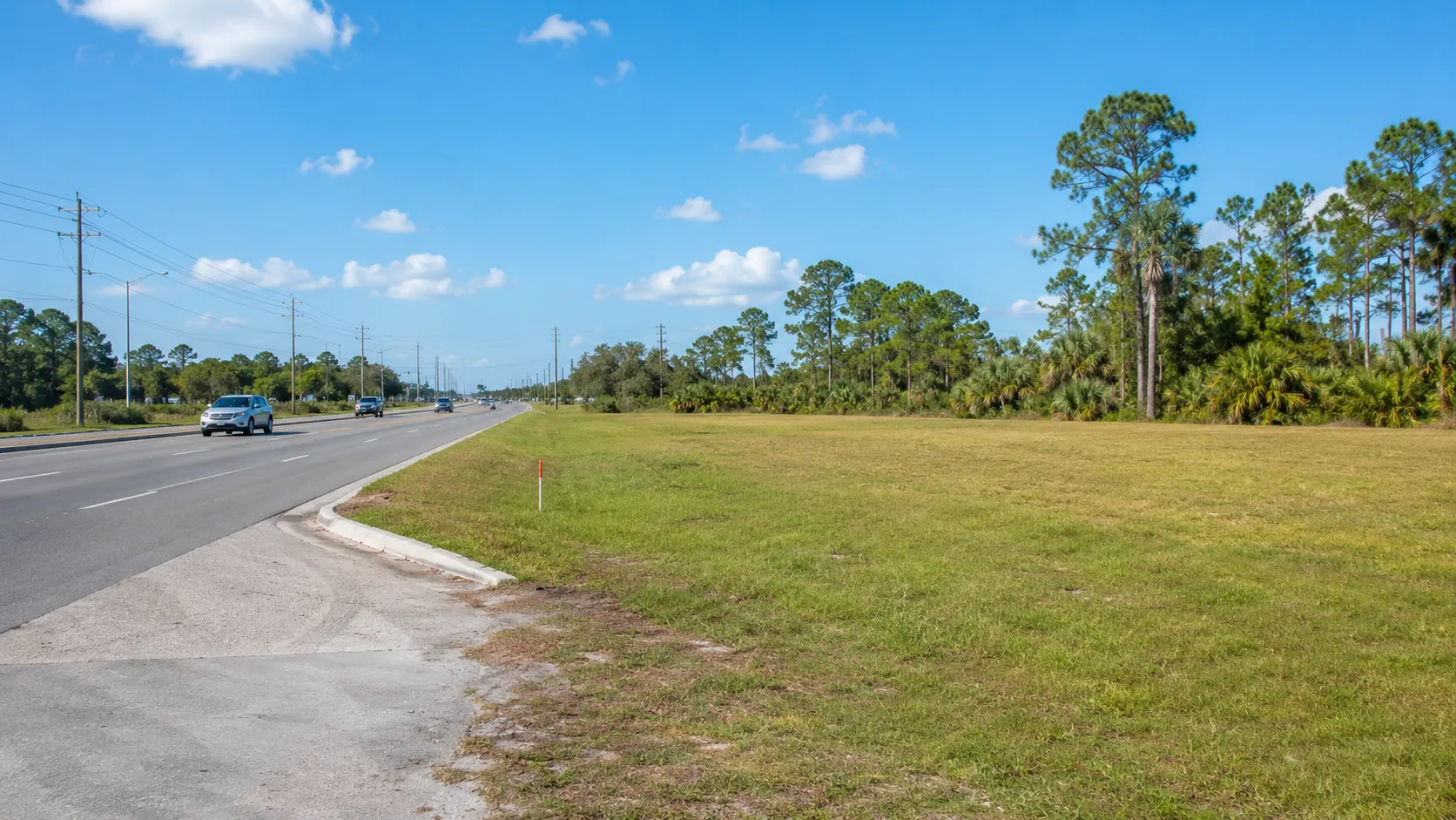 A vacant commercial parcel with arterial road frontage in a growing Florida town.